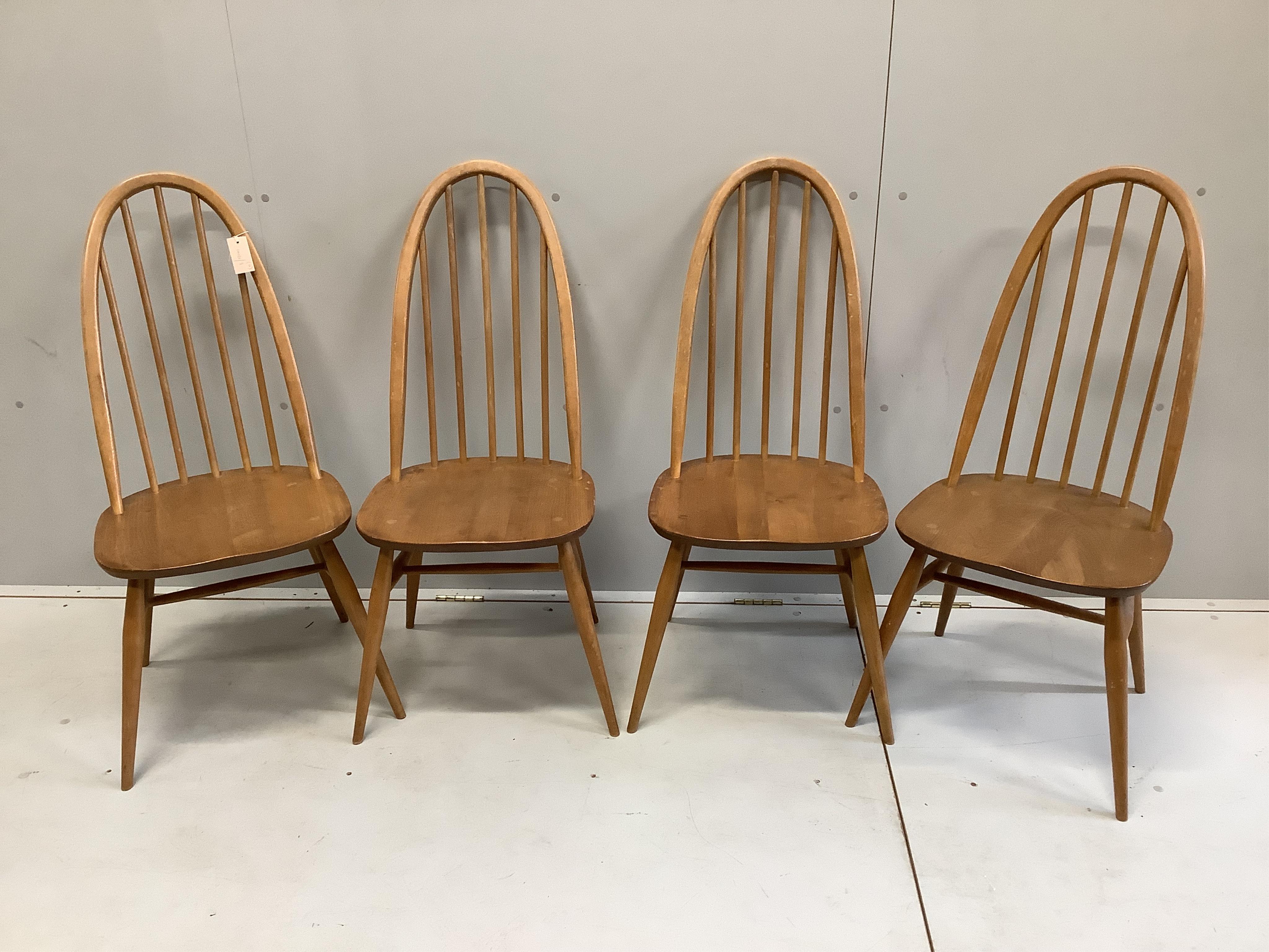 A set of four Ercol elm and beech comb back dining chairs, width 42cm, depth 41cm, height 96cm